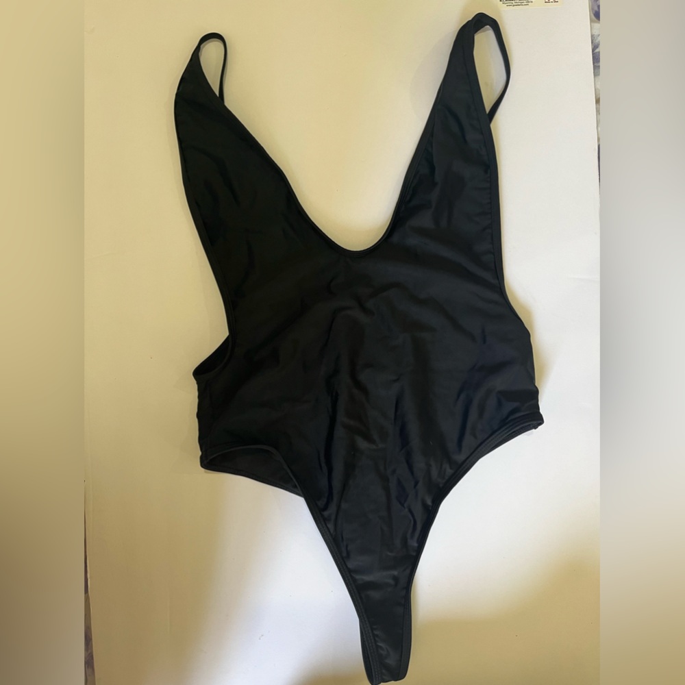 Woman’s medium black 1 piece low cut bathing suit
